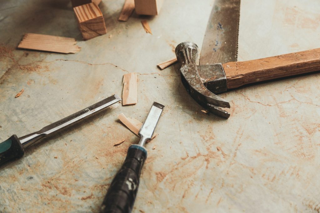 Closeup shot of handyman tools and a hammer on a table